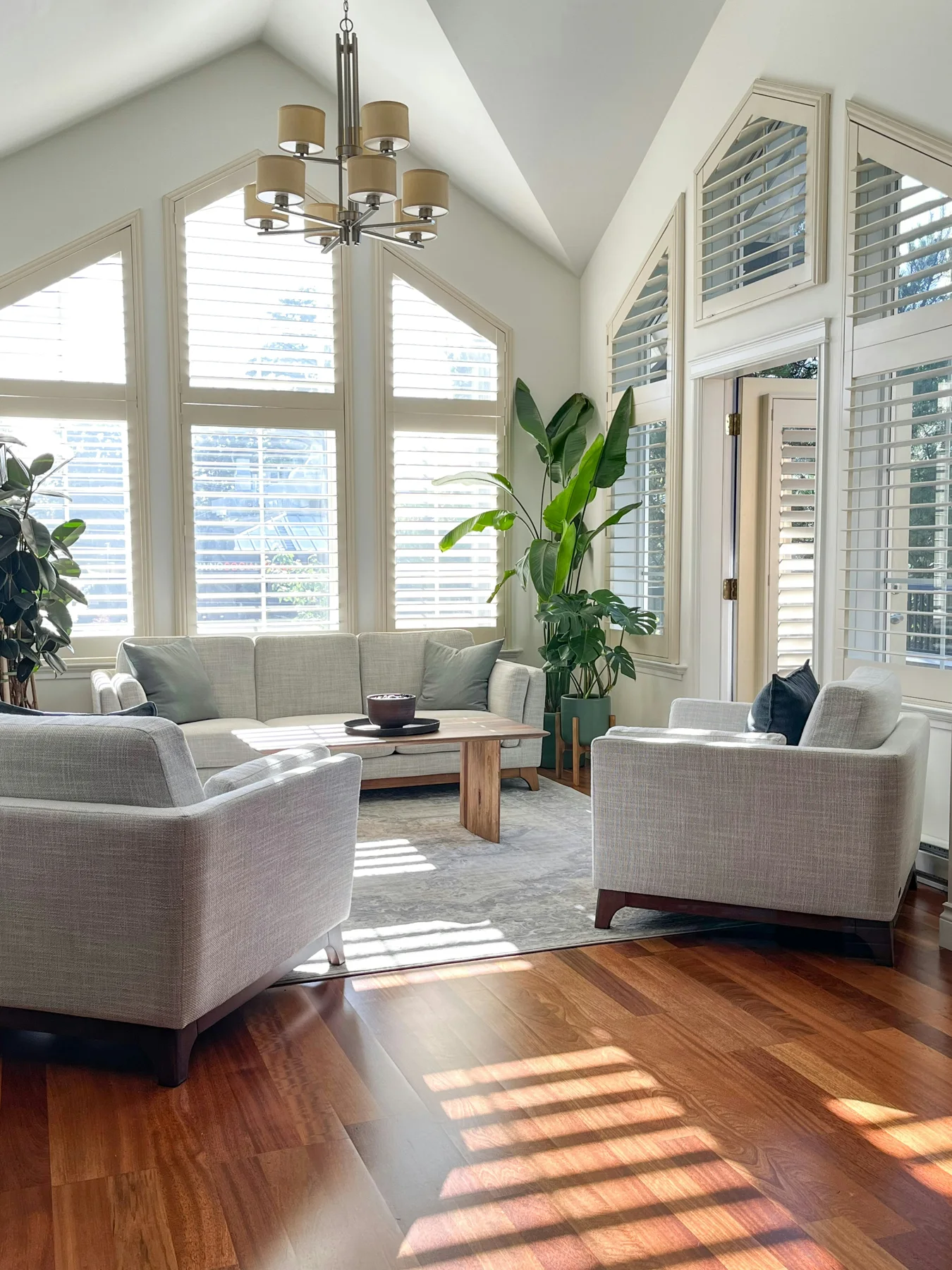 BC living room with a balanced seating group and shuttered windows